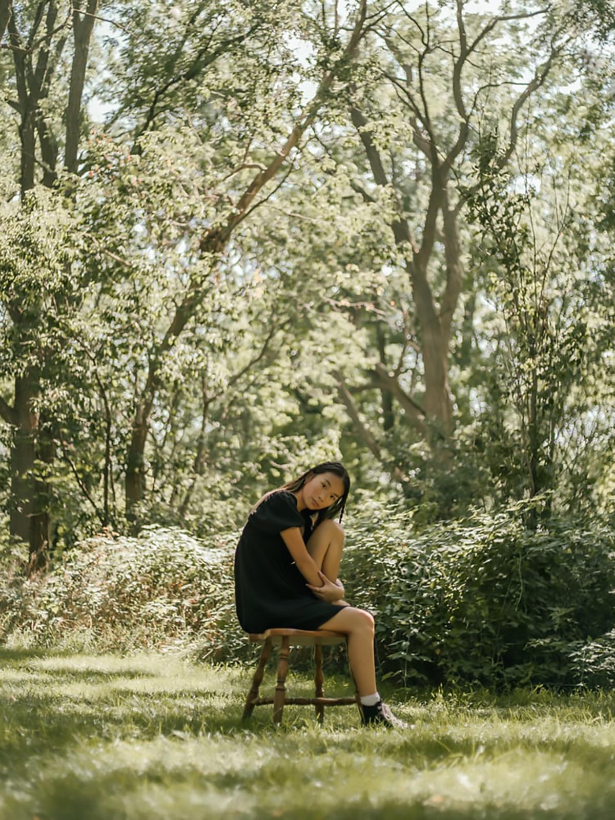 Nainen istuu tuolilla ulkona